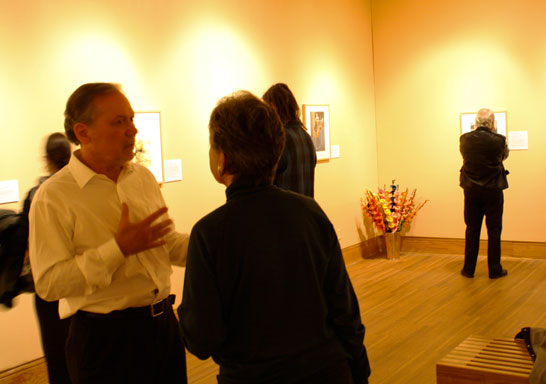 Berman talking to an attendant of the exhibit