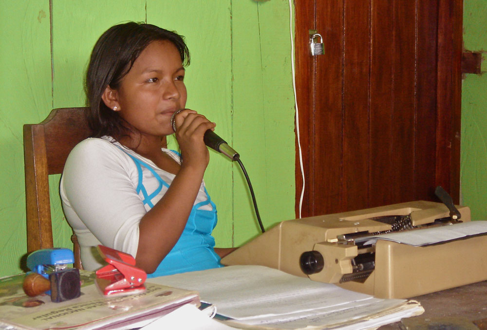 A community member uses a loudspeaker to spread news to her village. (Courtesy of Lucia Dura)
