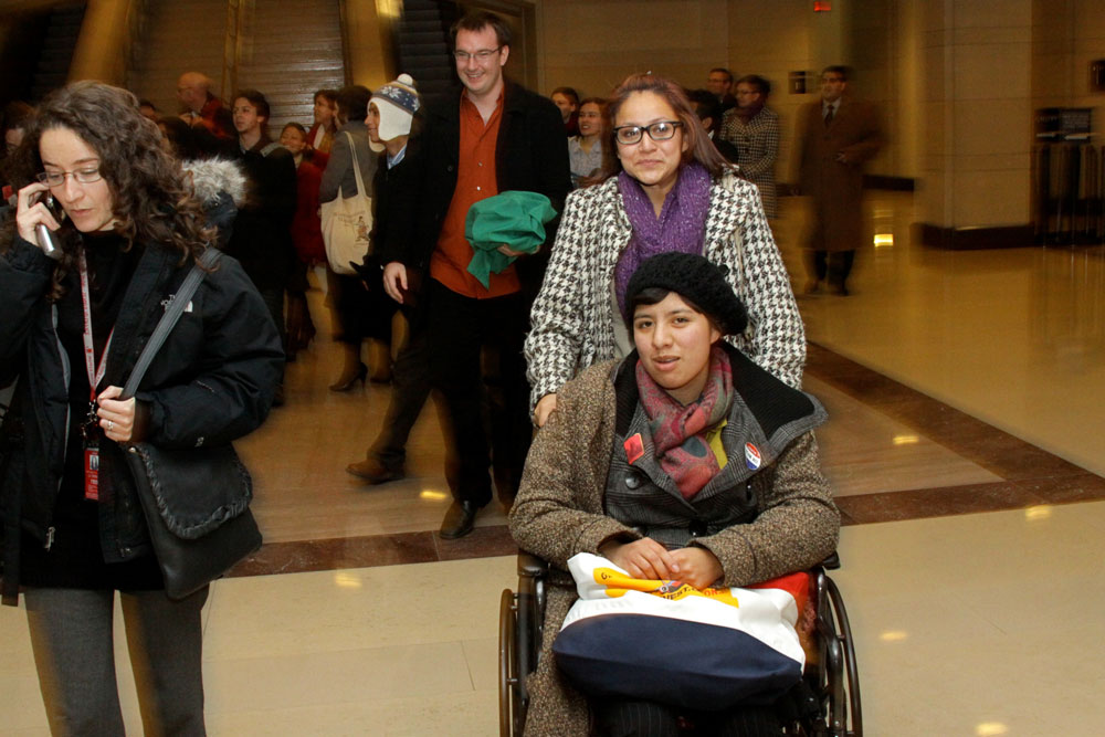 Lucinda Martinez, in the wheelchair, and Pamela Resendis are emotional as they leave the House chamber Wednesday after the House passed the Dream Act. Martinez fasted for 30 days to show support for the bill. (Raymundo Aguirre/SHFWire)