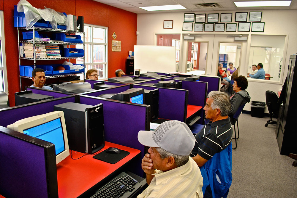 A group of aspiring U.S Citizens study their Citizenship exam material at La Fe's Cultural Technology Center. (Omar Lozano/Borderzine.com)