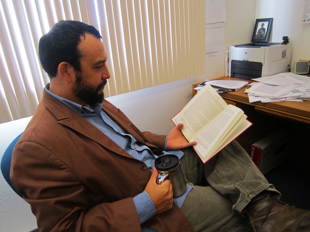 Professor Avant-Mier at his office at the Department of Communication at UTEP. (Adriana Macias/Borderzine.com)