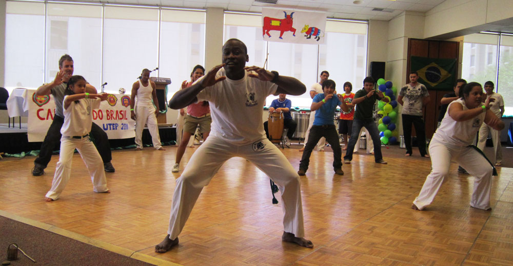 Members of Capoeira Quinto Sol give a lesson to the Brazilian festival attendees. (Adriana Macias/Borderzine.com)