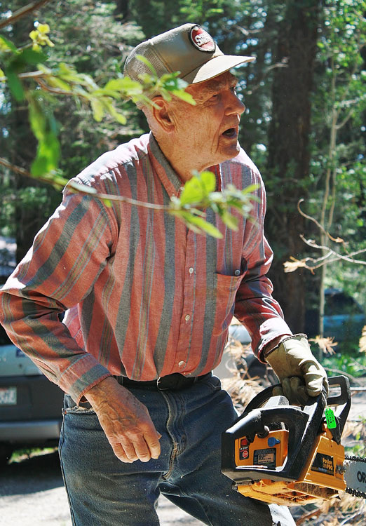 Louie Long, of Cloudcroft,  WORKING on cutting down a dead tree. (Cheryl Howard/Borderzine.com)