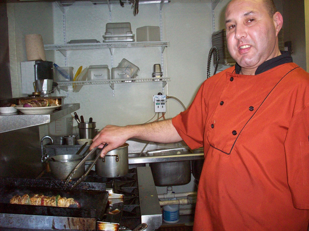 Zino Souikni cooking shish kebab. (Anoushka Valodya/Borderzine.com)
