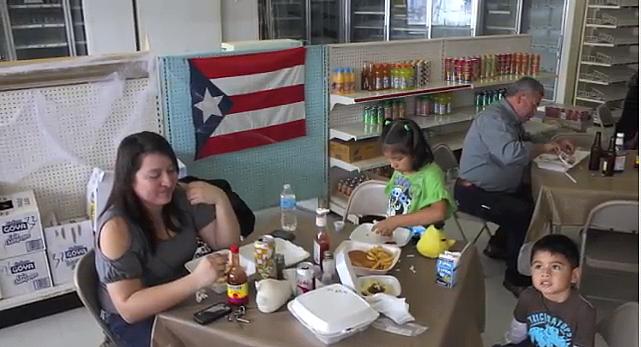 Angelica Sanchez and her children enjoy Puerto Rican food at Maracas. (Meili Robles/Borderzine.com)