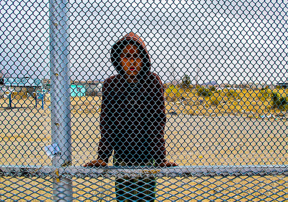 boy at border fence