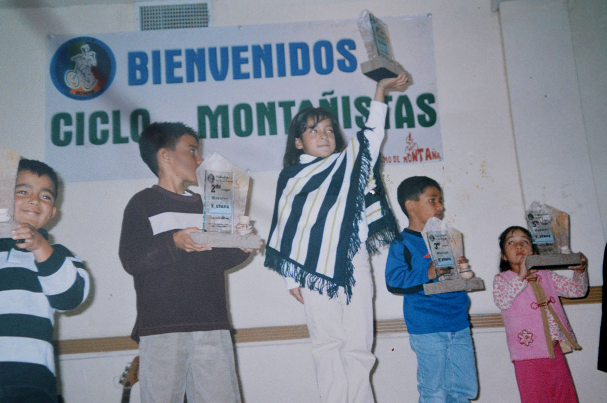 Fernanda Polanco proudly holds her fist place plaque in the 2005 Mountain Race State Championship. “She had to drop the mountain cycling team because the boys would bother her for being the only girl,” her mother said. (Courtesy of Fernanda Polanco)