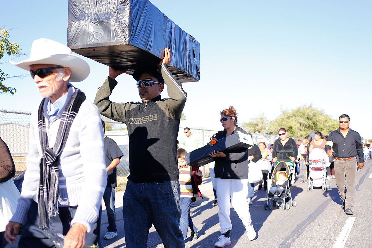 Juan Ortiz carries a casket as part of a group of about a hundred and fifty persons who participated in the procession for the Day of the Dead. (Edwin Delgado/Borderzine.com)