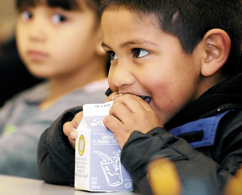 Daniel Bailon, 6, drinks his milk in a classroom at Columbus Elementary. Nearly all students at the school receive free and reduced-price breakfasts and lunches. (Robin Zielinski - Sun-News)