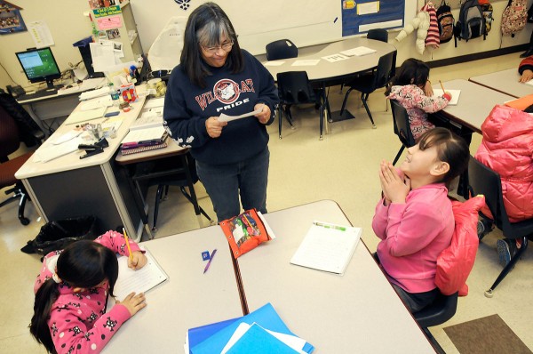 Columbus Elementary School teacher Lourdes Espinoza goes over dictation exercises with her fourth grade dual-language class. Espinoza was a Palomas student herself, crossing the U.S.-Mexico border for school each day when the agreement permitted Mexican students to attend school in New Mexico. (Robin Zielinski - Sun-News) 