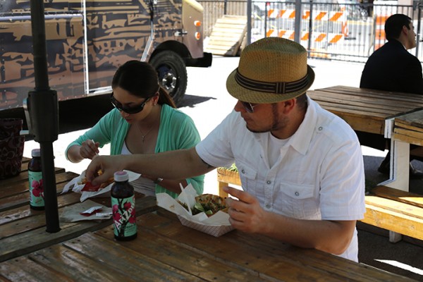 Alejandra Martinez and Leonardo Pereda eat fish tacos from the Reef Mobile Kitchen at the Foodville Truck Park in El Paso. (Laura Camden/Borderzine.com)