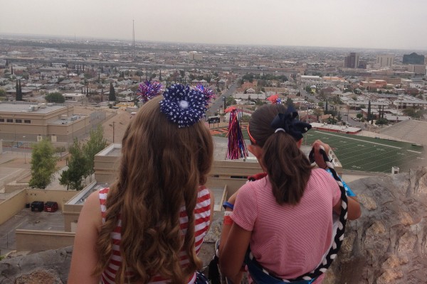 Two young girls dressed up to celebrate the Fourth of July take in the scenic view of El Paso, Texas, and Juarez, Mexico, from Tom Lea Park on Rim Road. Photo credit: Kate Gannon