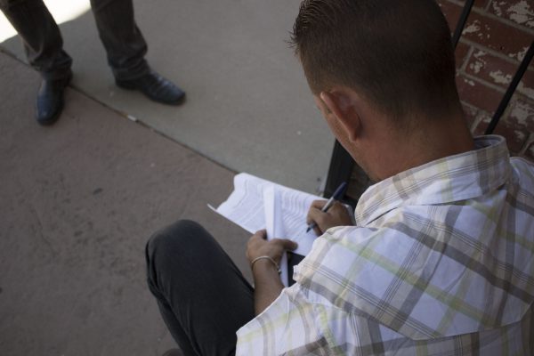 A newly arrived Cuban migrant fills out paperwork in El Paso.