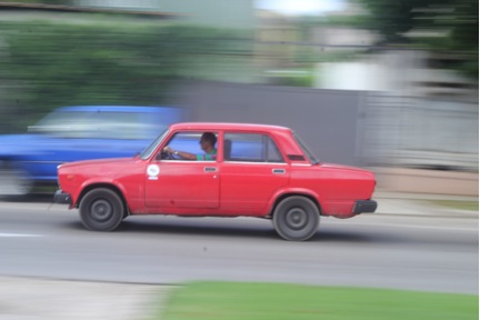 A car zooms by in Havana, Cuba.