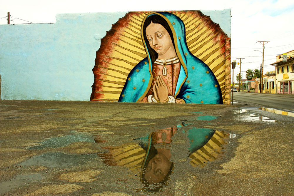 Reflection of the Virgin. The mural of the Virgin of Guadalupe is located next to a gas station in the Lower Valley of El Paso. (Cynthia Carol Almodovar/Borderzine.com)