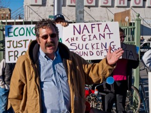 Dr. Joe Heyman, a volunteer with Occupy El Paso and a Professor at UTEP, speaks at Santa Fe bridge. (Robert Brown/Borderzine.com)