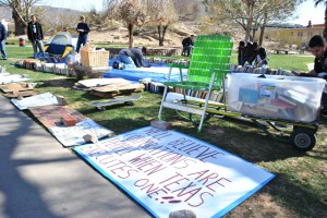 Members of Occupy El Paso help by making poster signs and setting up a tent that has become the symbol of the Occupy movement. (Lourdes Marie Ortiz/Borderzine.com)