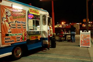 A family having dinner at Little Jimmis mobile food truck, parked at his usual spot in El Paso’s Lower Valley in front of the K-mart on Zaragosa. (Kristian Hernandez/Borderzine.com)