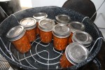 As soon as all the jars are loaded in, they are submerged into the boiling water, the lid goes on and the bath starts, adjusting for altitude. (Cheryl Howard/Borderzine.com)