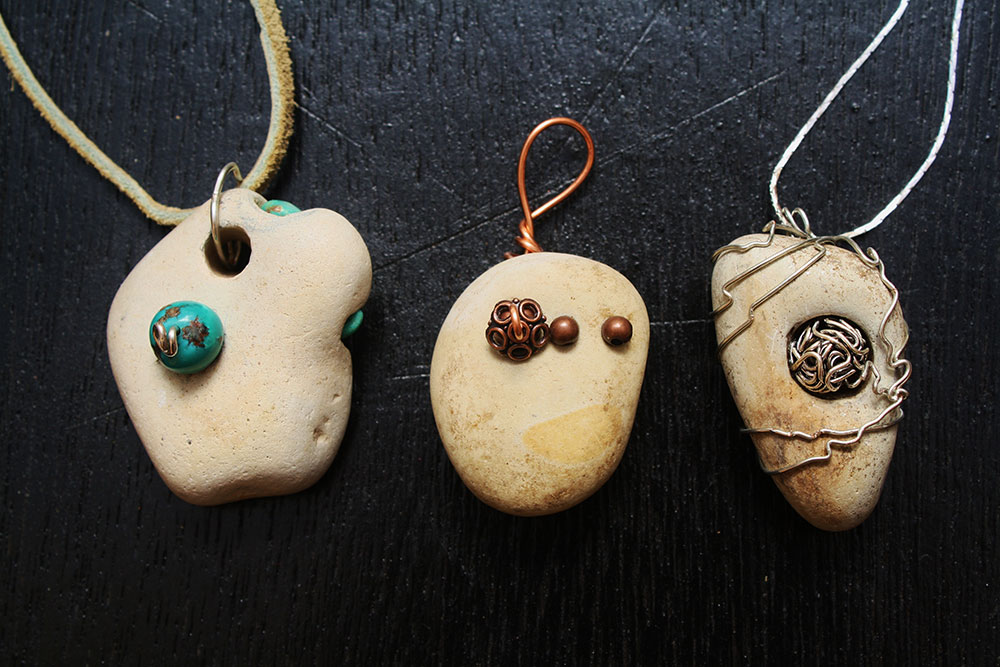 Stones with holes made into pendants. (Cheryl Howard/Borderzine.com)