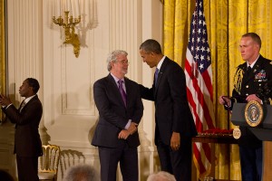 President Barack Obama greets filmmaker George Lucas. Lucas was awarded the National Medal of Arts for his cinematic work. A military aide prepares to hand the medal to the president. (Caleigh Bourgeois/SHFWire)