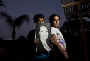 Nine-year-old twins Isaac and Rebecca Alvarado with an image of the their mother, Valeria Tachiquin-Alvarado, who was shot and killed Sept. 28, 2012, by a border agent in Chula Vista, Calif. (Nick Oza /The Republic)