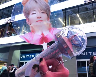Fans waiting for doors to open at the United Center in Chicago can buy Seventeen's official lightstick and other merchandise.