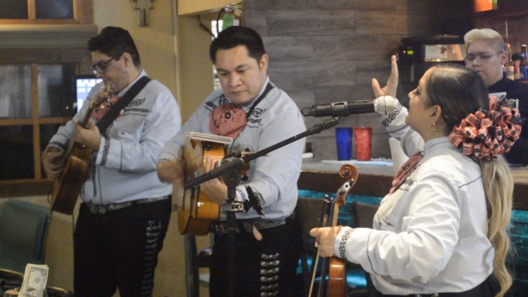 Alejandro Ramos (left), Sergio Ramos (middle) and Stephanie Cramer perform as Mariachi Trio de México at a restaurant in El Paso on Sept. 2, 2022.