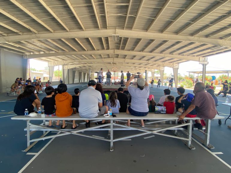 The audience watches as the match between local Luchadores is about to begin outside of the Chamizal Community Center and Library.
